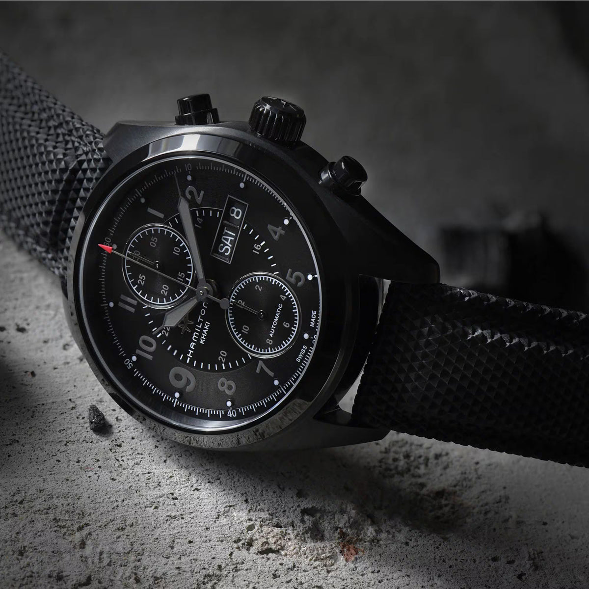 Hamilton Khaki Field H71626735 atmospheric low-light view emphasizing the stealthy design of the dial and case layout