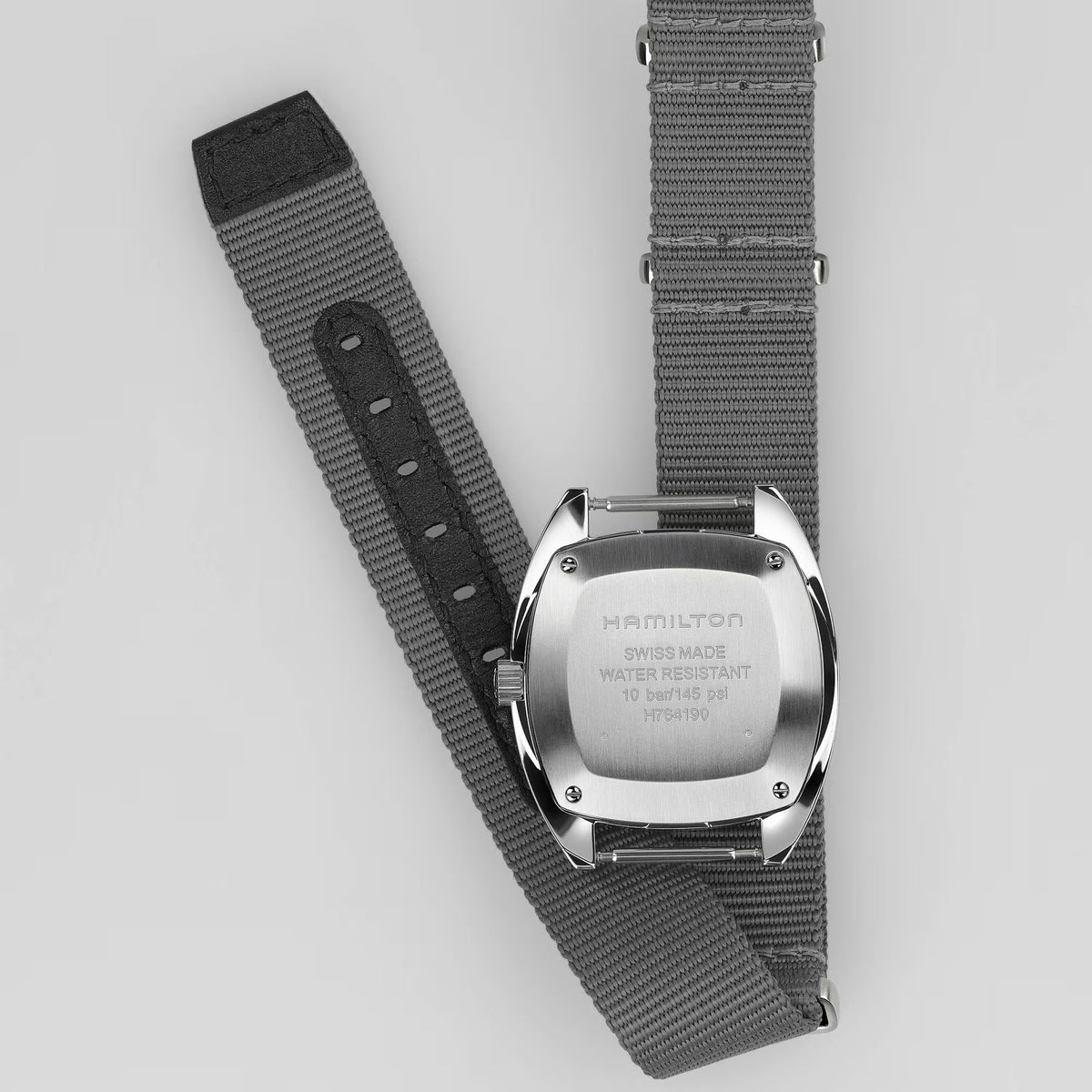 Hamilton mechanical pilot watch showing clasp and case back on dark gray NATO strap