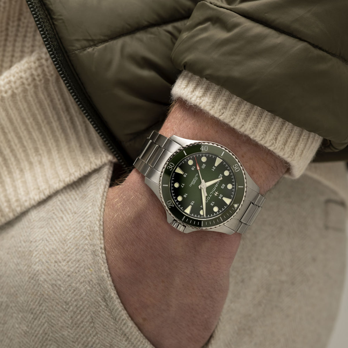 Hamilton Khaki Navy Scuba H82525160 automatic watch wrist shot styled with olive jacket and cream jumper showing green dial
