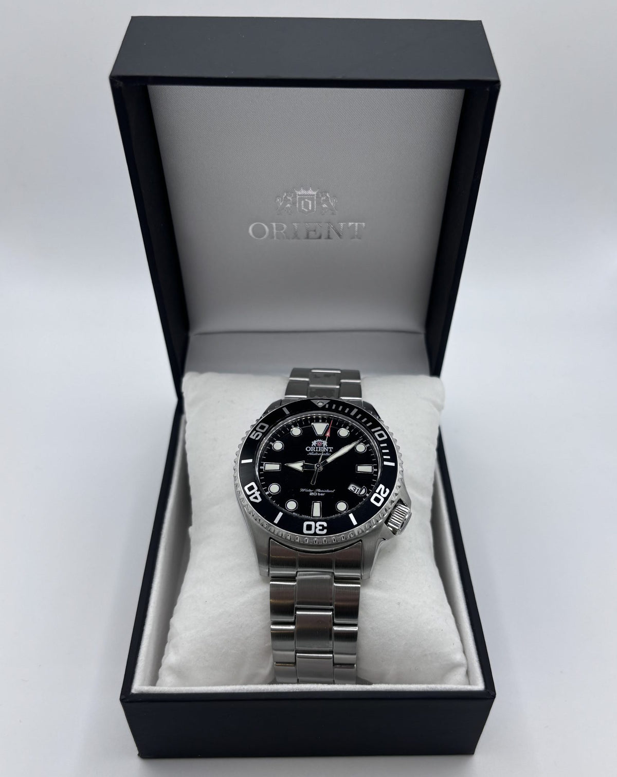 Men's steel automatic watch in open black presentation box with black dial
