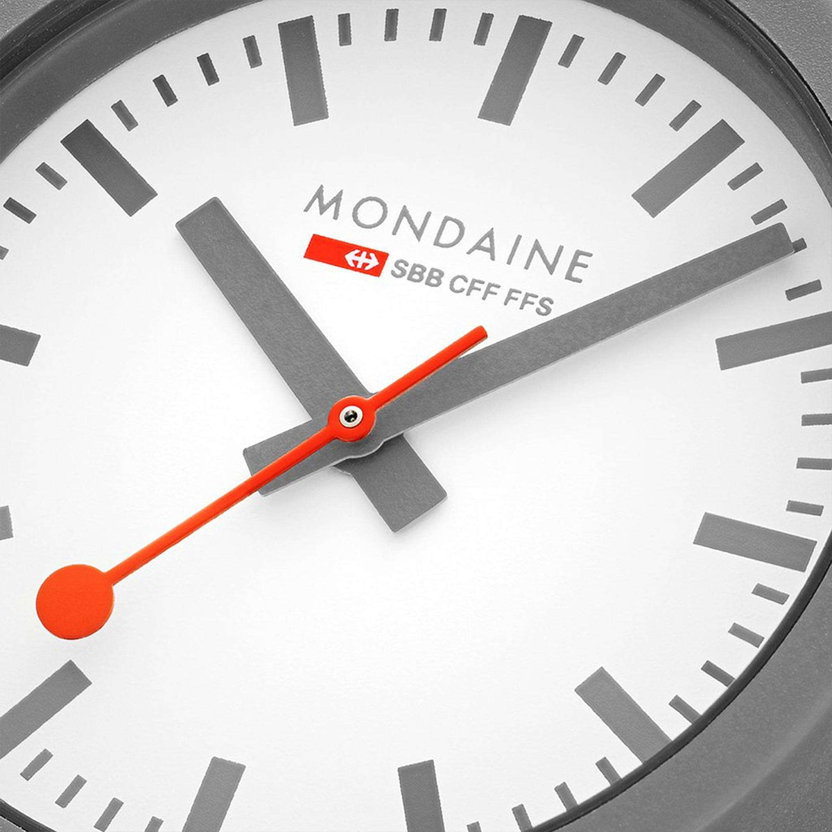 Close-up quartz watch dial with orange hands and gray hour markers