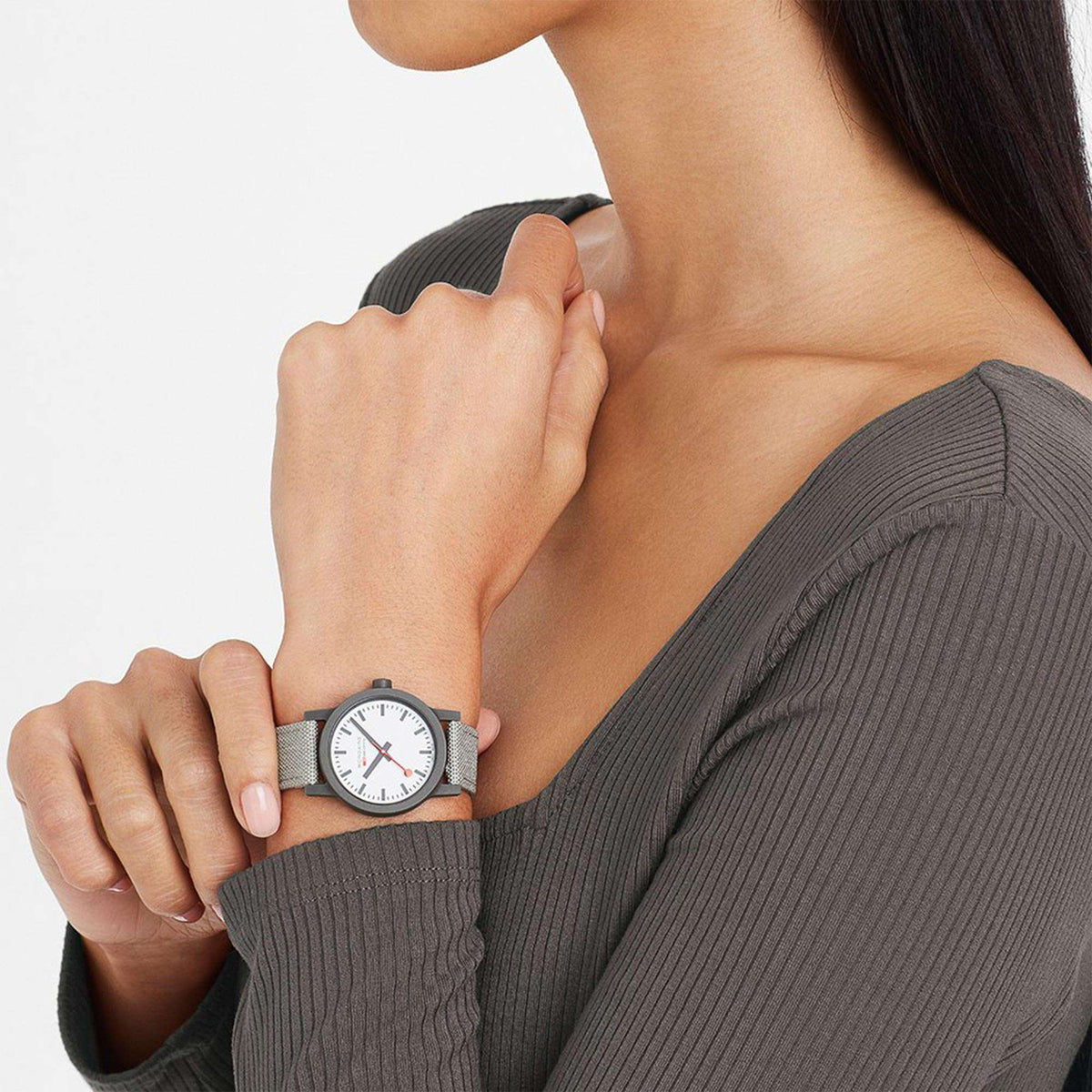 Quartz watch on wrist with gray case, white dial, and dark gray textile strap