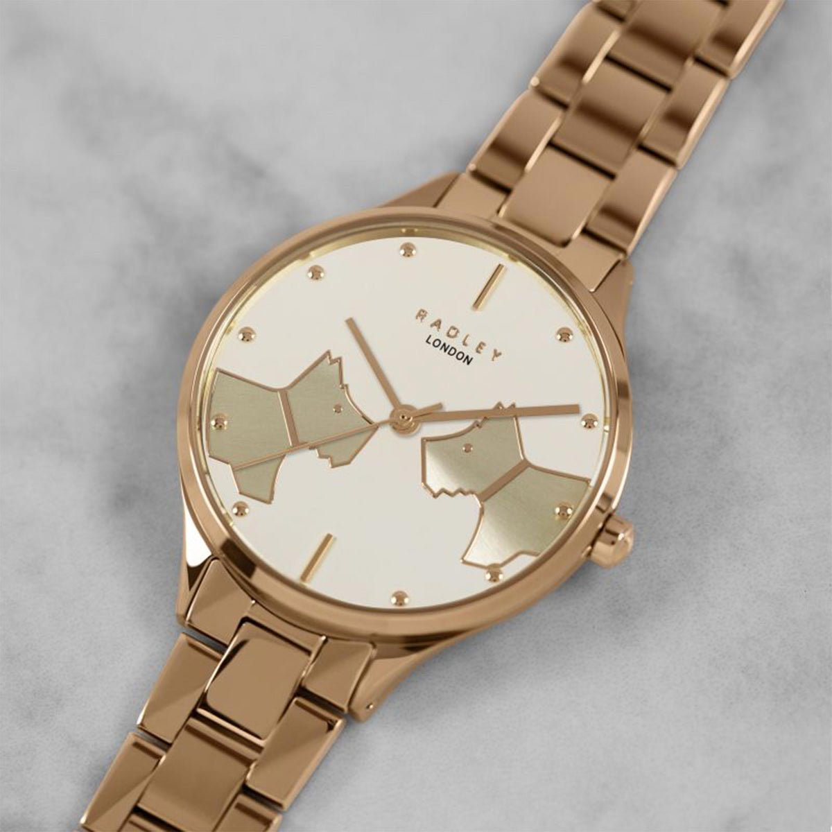 Rose gold ladies bracelet watch, angled view, cream dial with map-style hands and markers