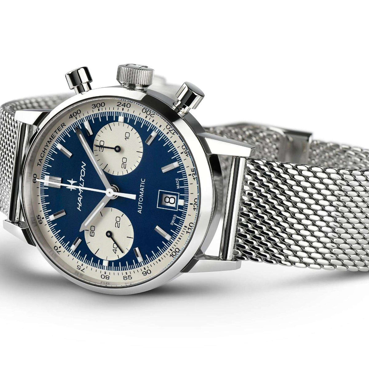 Automatic chronograph watch with blue face, steel bezel, pushers, and mesh strap