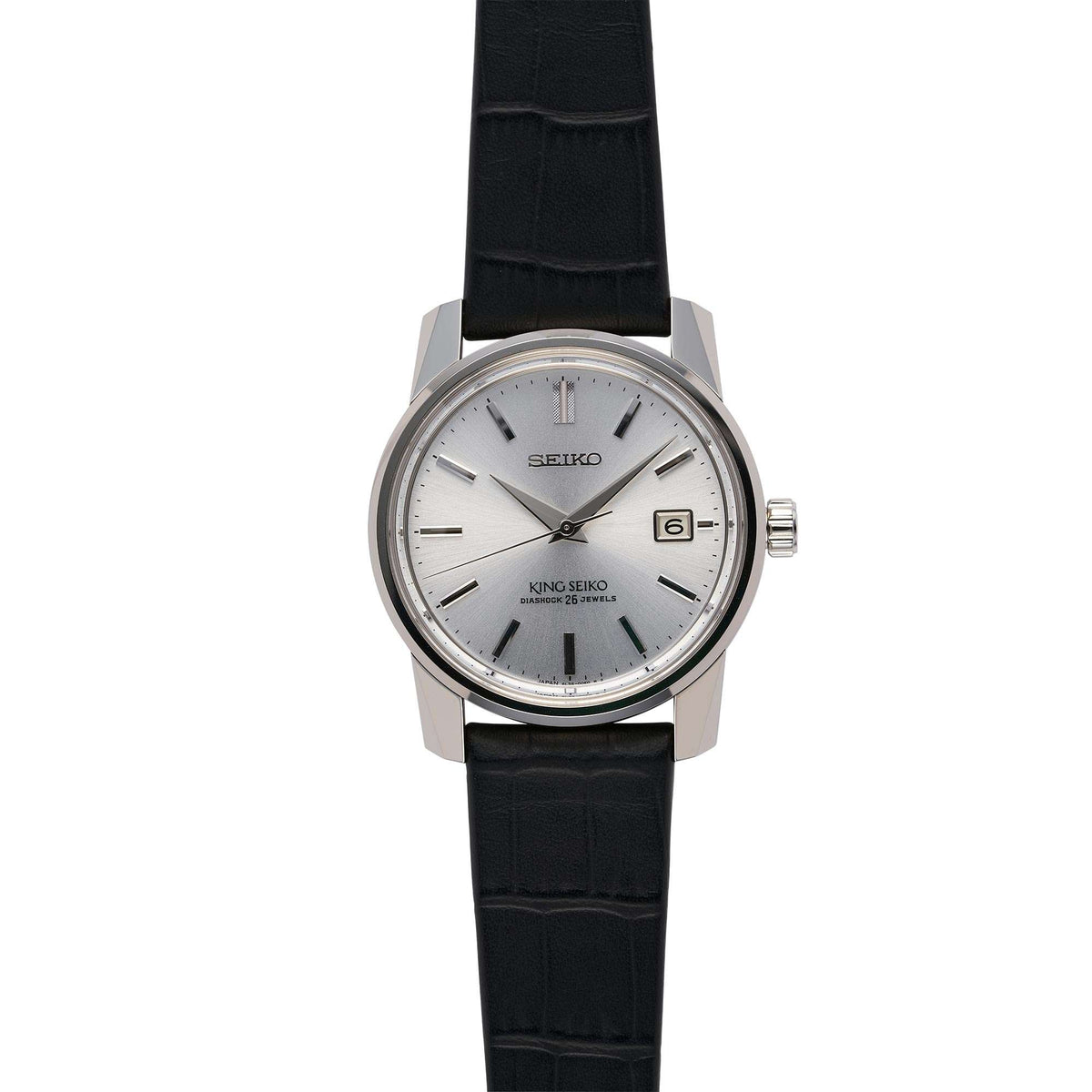 Men's automatic wristwatch with silver dial, black leather strap, side profile with crown.