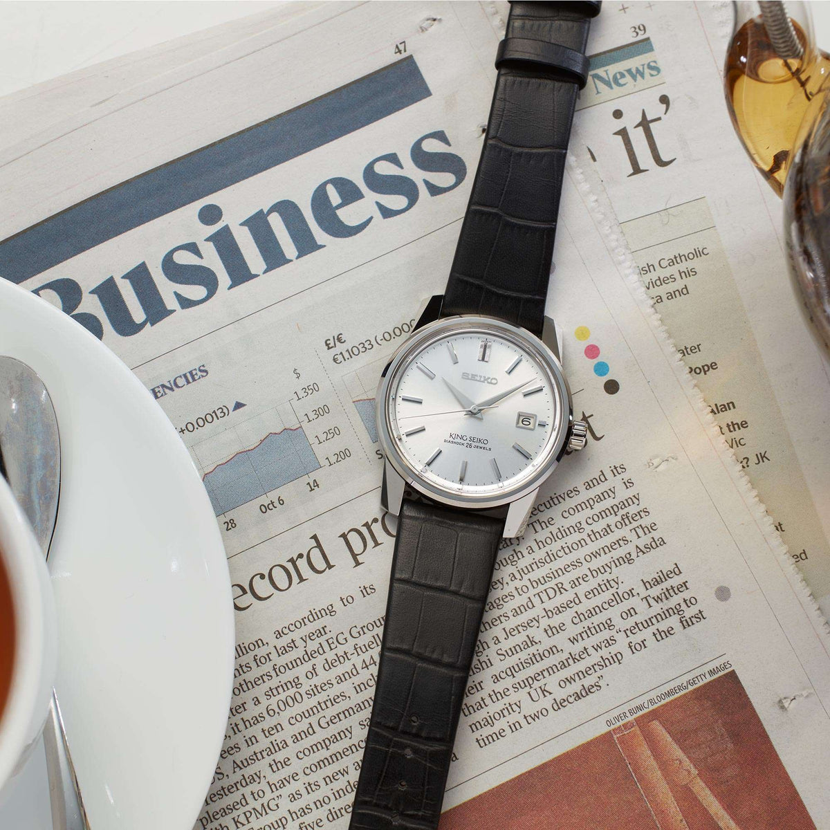 Men's automatic wristwatch with silver dial, black leather strap, date window at 6.