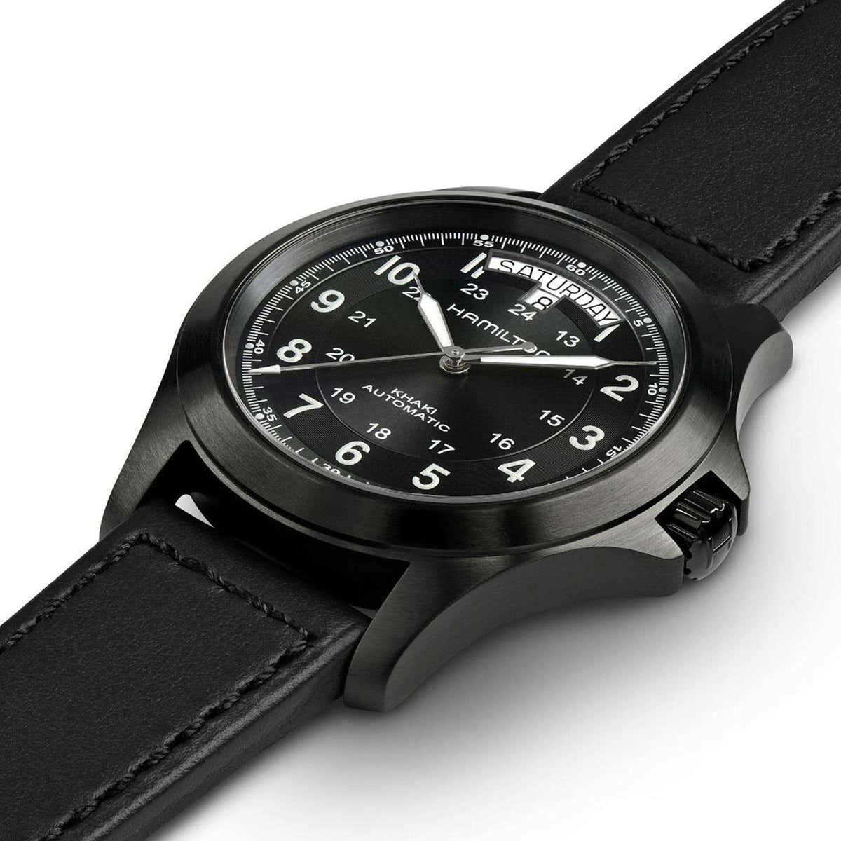 Men's black dial automatic watch close-up with black leather strap and textured bezel.