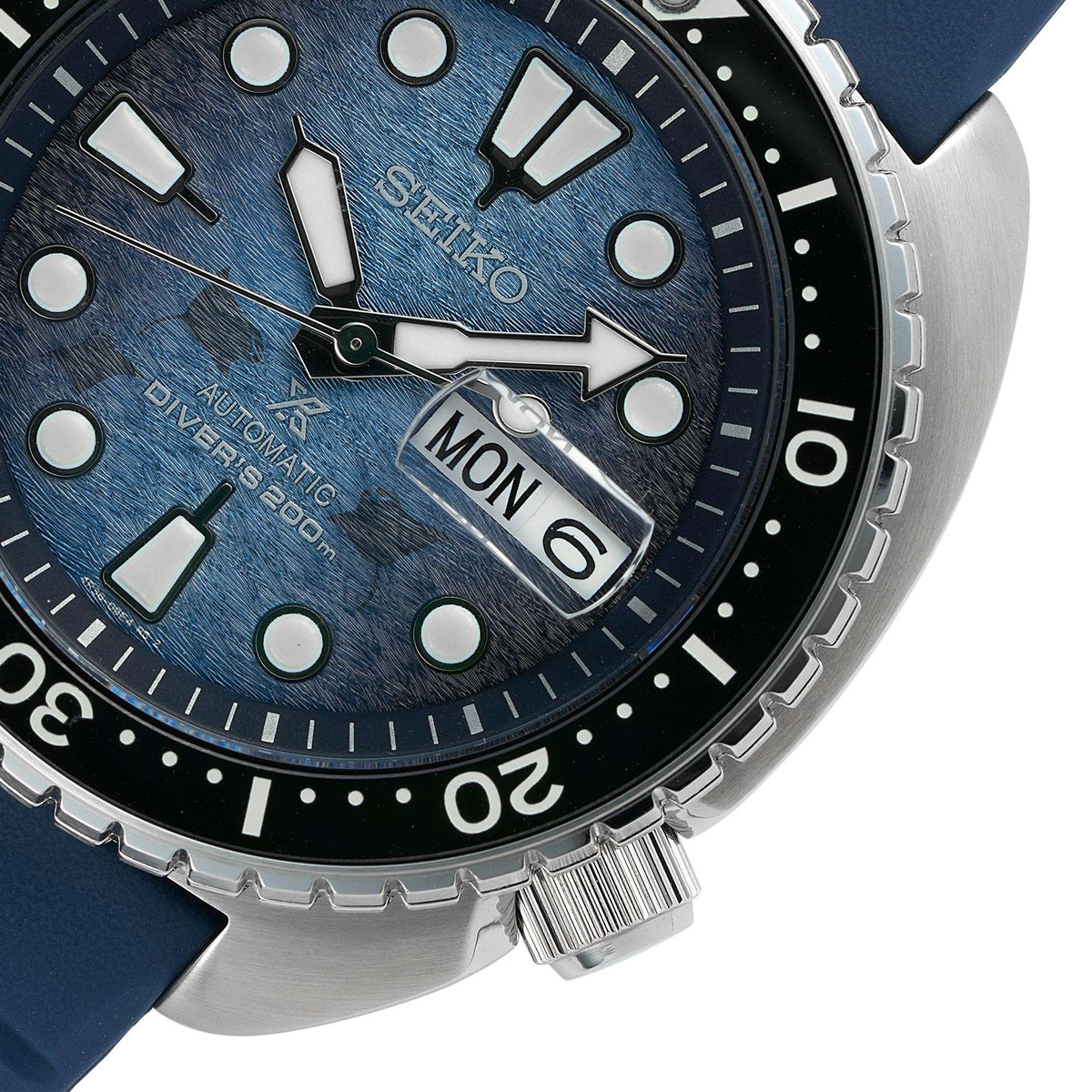 Seiko blue textured dial dive watch close-up with MON date window and marker bezel