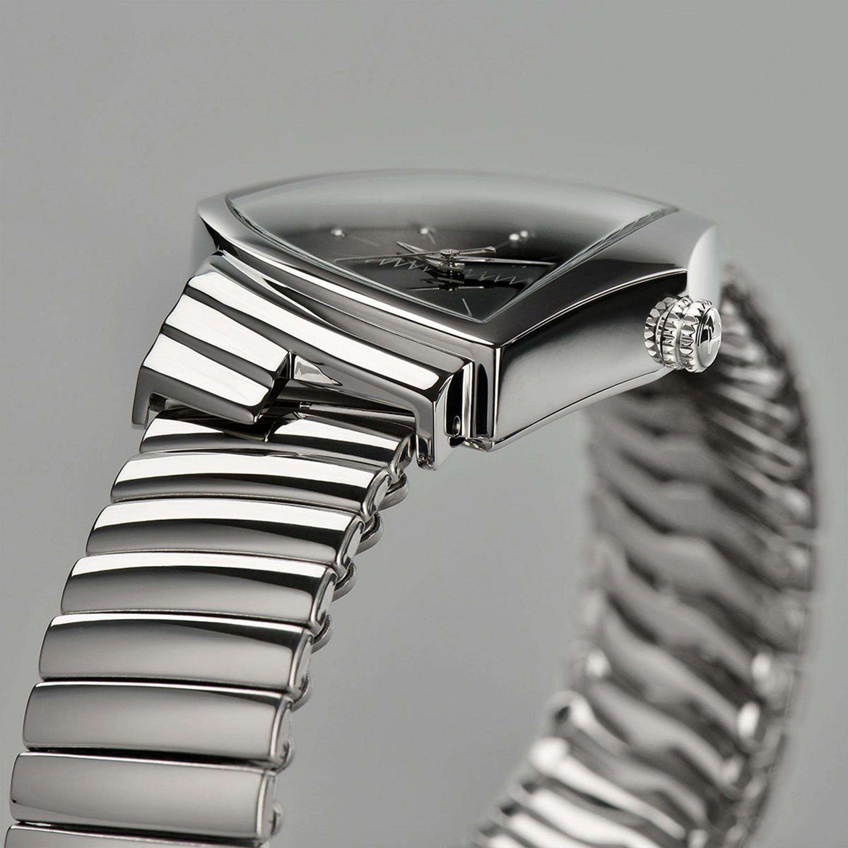 Profile view of a Hamilton Ventura watch showing its triangular case and stainless steel flex bracelet
