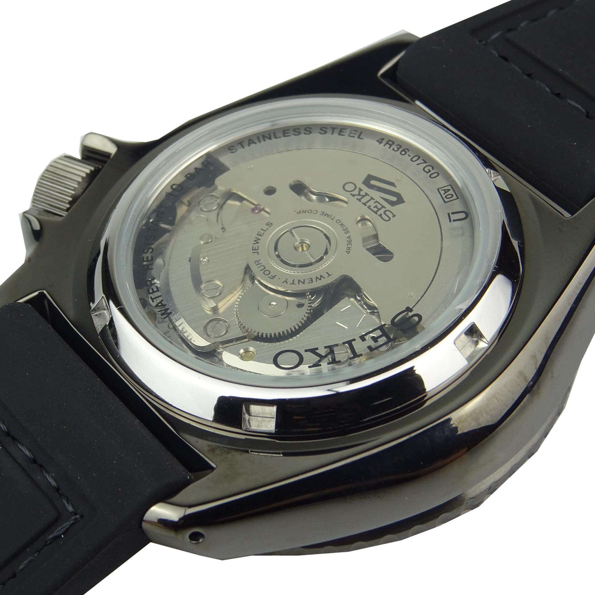 Men's automatic watch caseback with visible mechanical movement under a clear window.