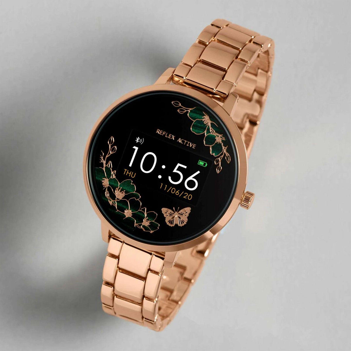 Rose gold smartwatch angled view with black floral dial and metal link bracelet