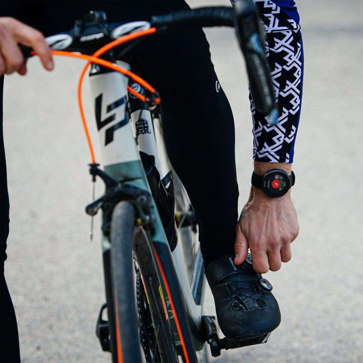 Black rubber-strap smartwatch on wrist with dark digital dial