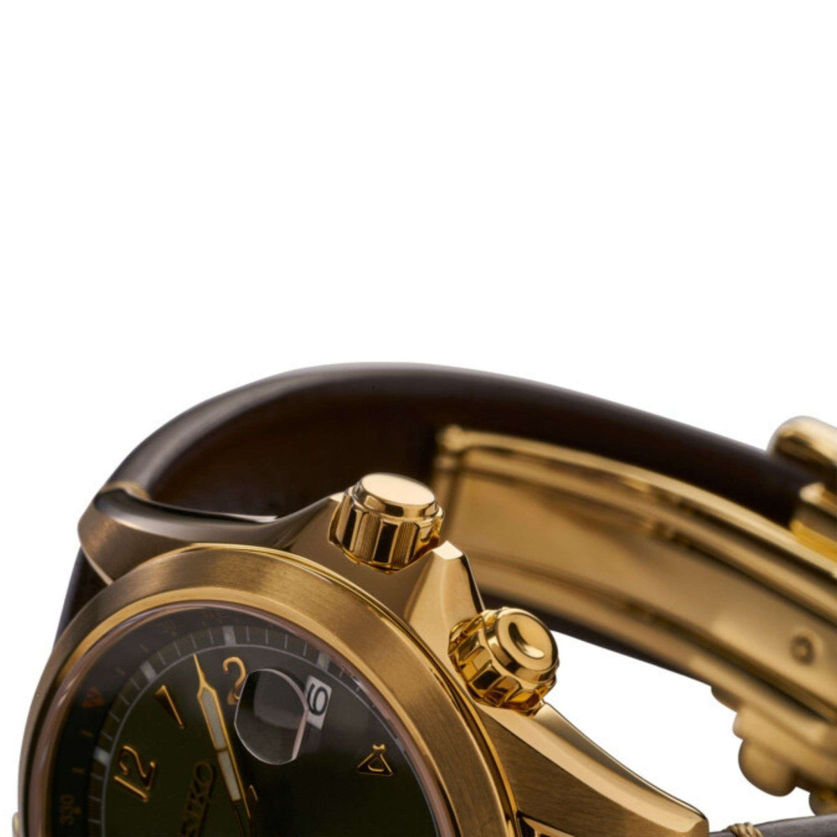 Close-up of gold-tone crown and bezel on men's watch with brown leather strap