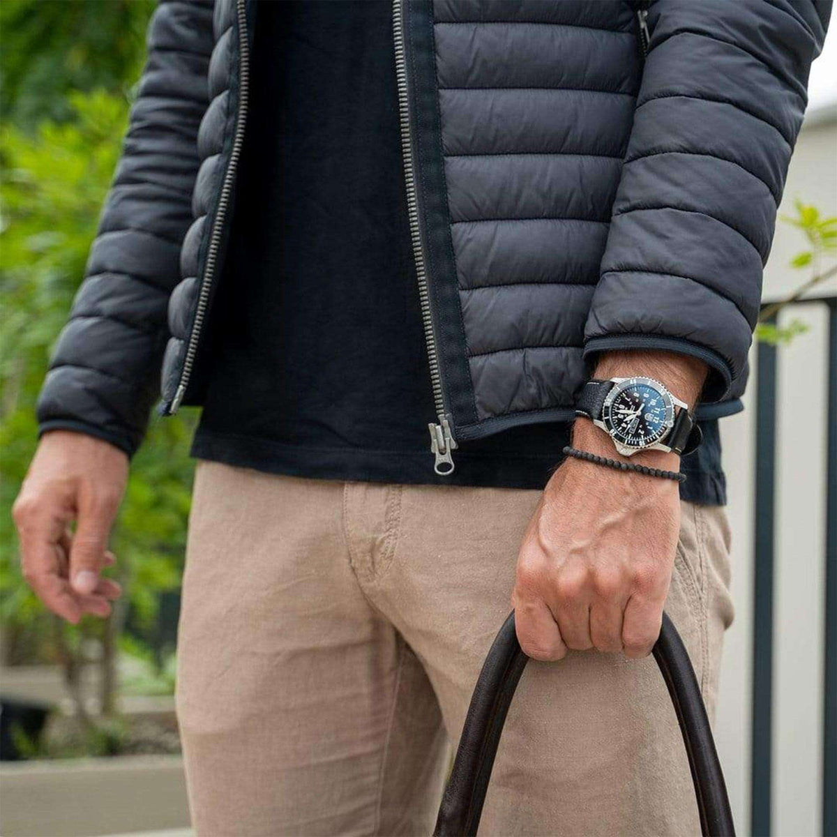 Men's wrist-worn sport watch with black leather strap and green luminous dial