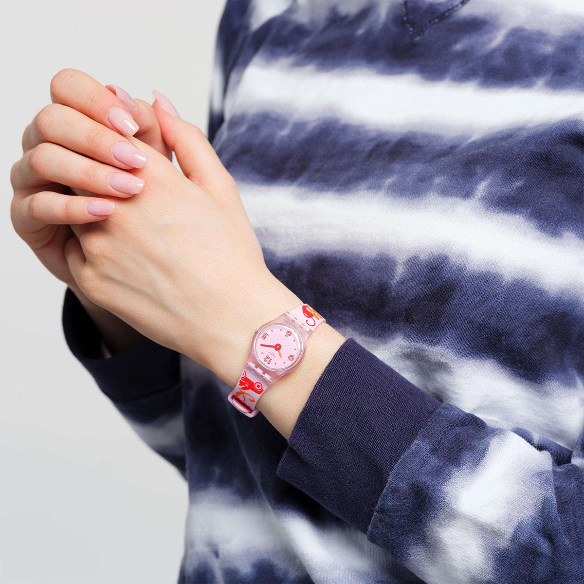 Ladies quartz watch on wrist with pink dial and clear pink silicone strap