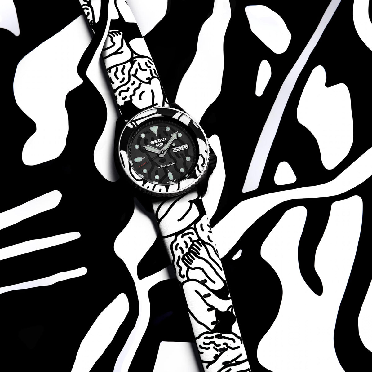Seiko 5 Sports watch SRPG43K1 showcased against a monochrome Auto Moai graphic background