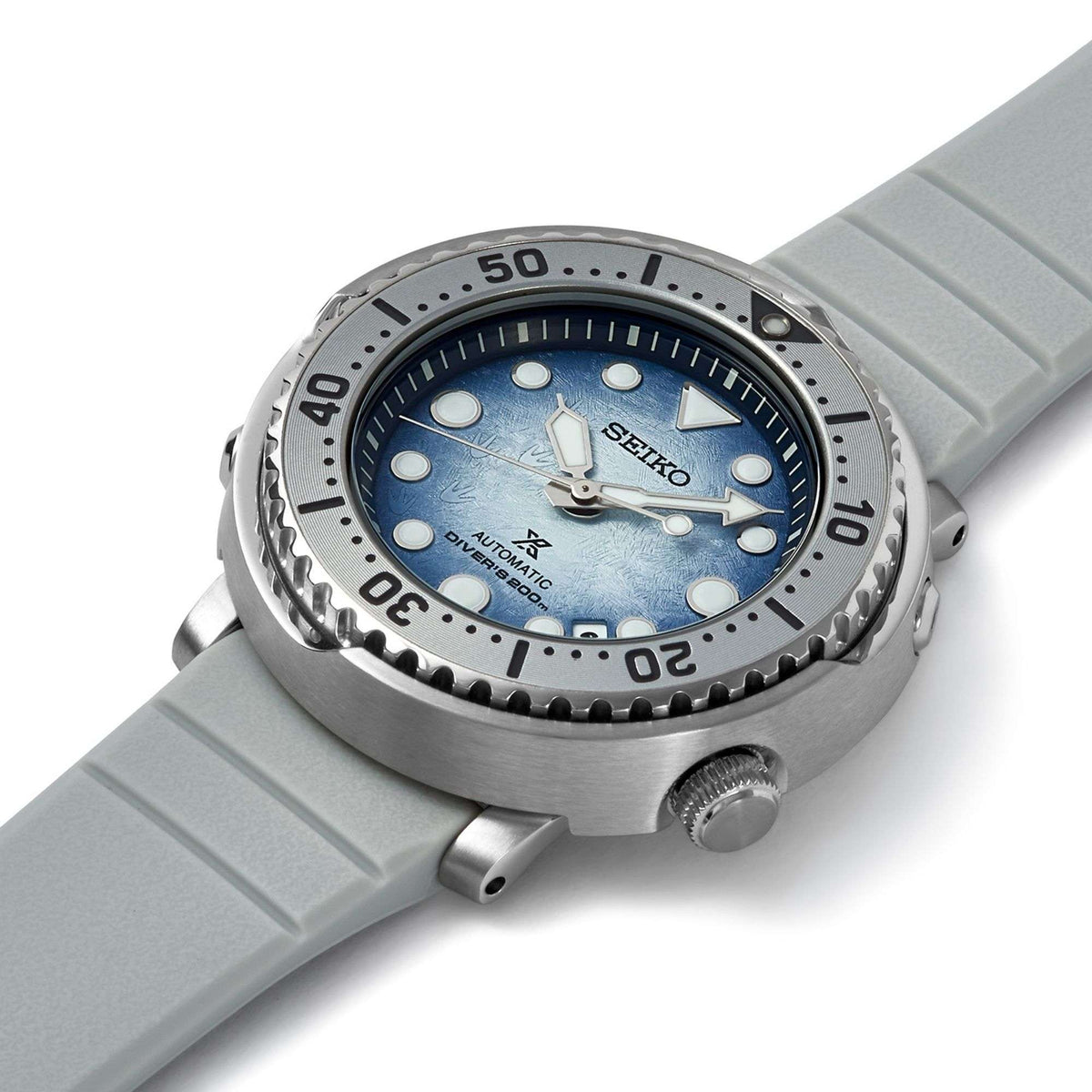 Men's automatic dive watch with blue dial, steel bezel, and light gray silicone strap