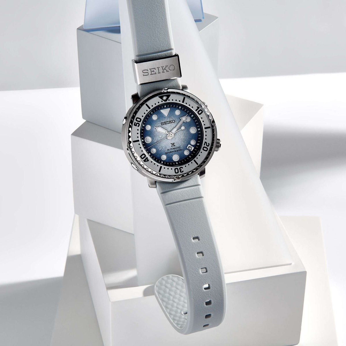 Men's automatic diver watch on light gray silicone strap, blue dial and steel bezel