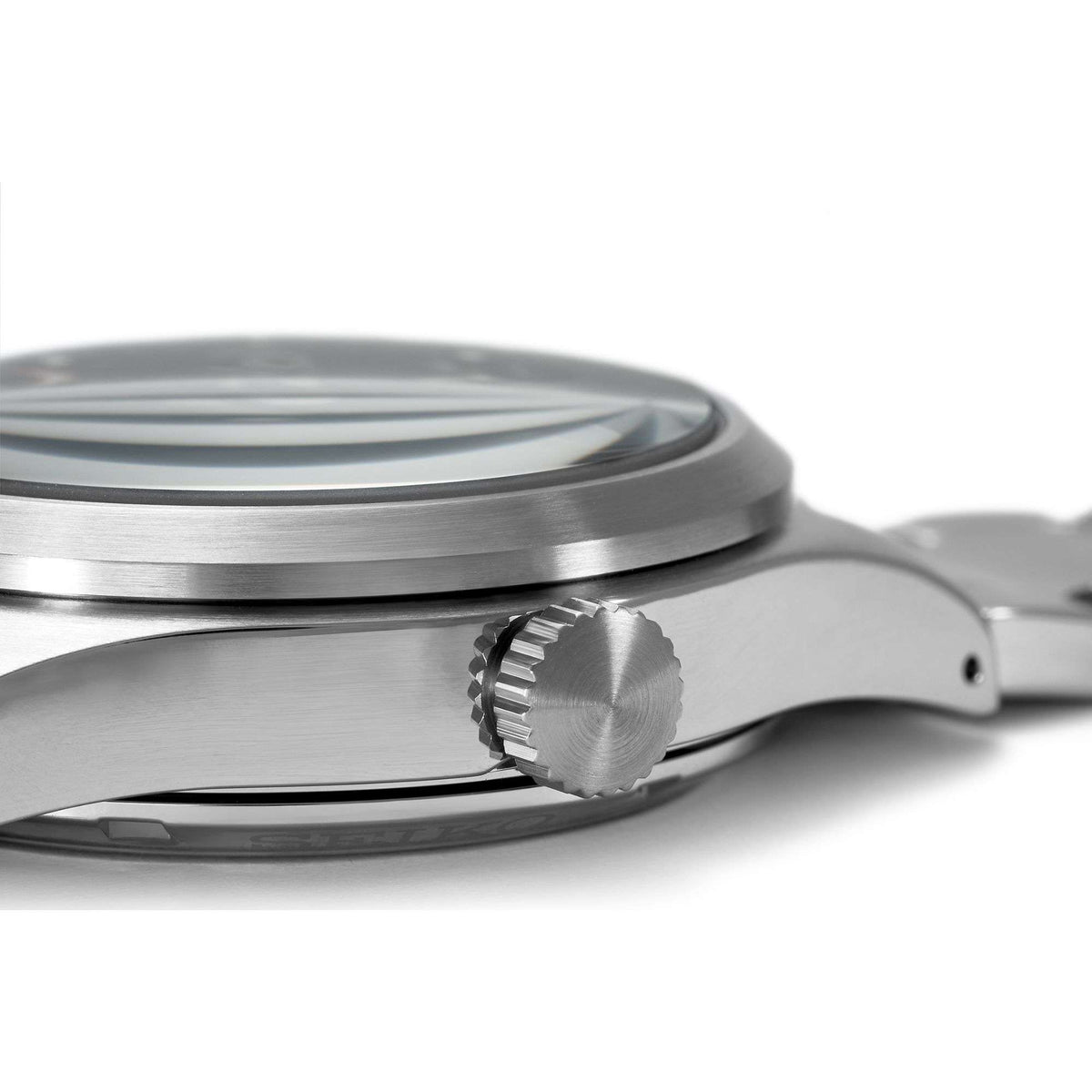 Stainless steel watch case side with ridged crown detail over a black dial
