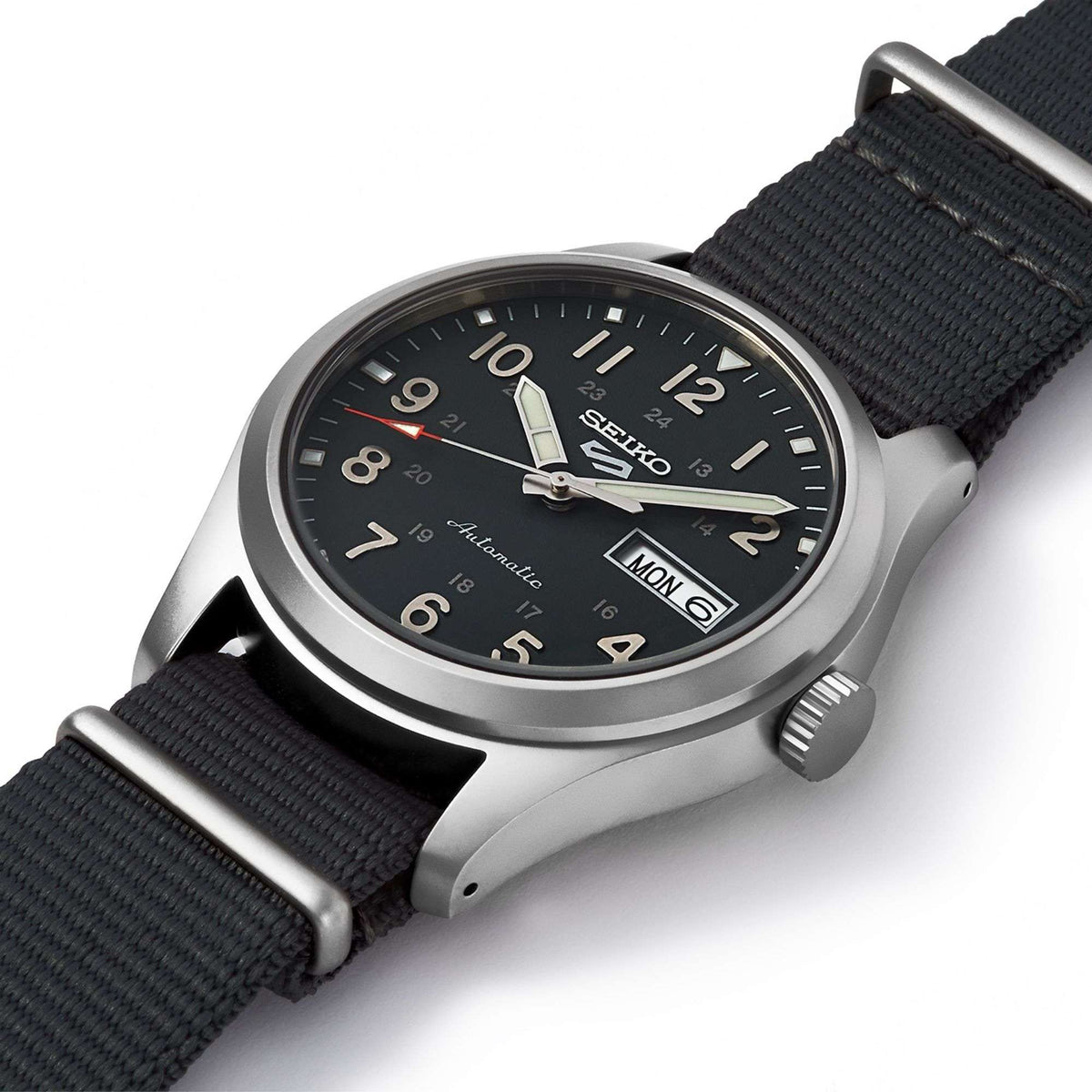 Men's Seiko field watch on dark grey NATO strap, angled view, day/date Monday 6