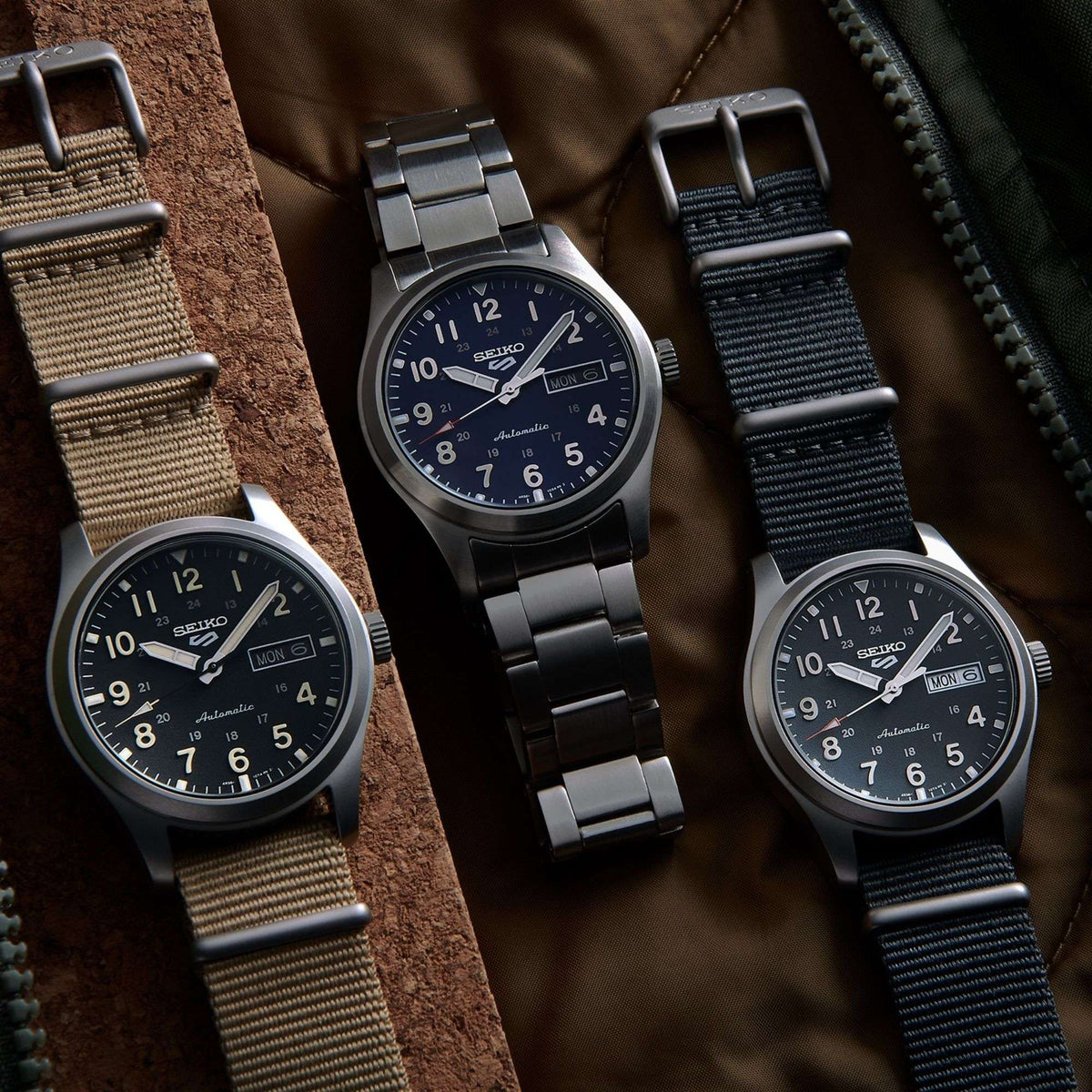 Four men's field watches with NATO straps and different dial/strap colors