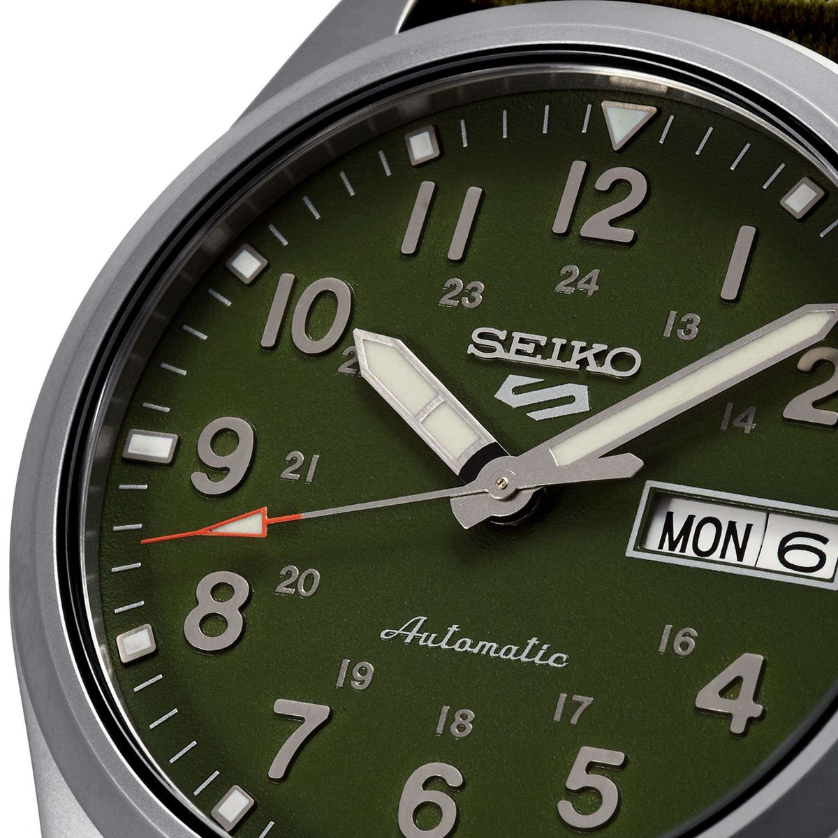 Seiko 5 Sports green dial automatic field watch close-up with MON date window