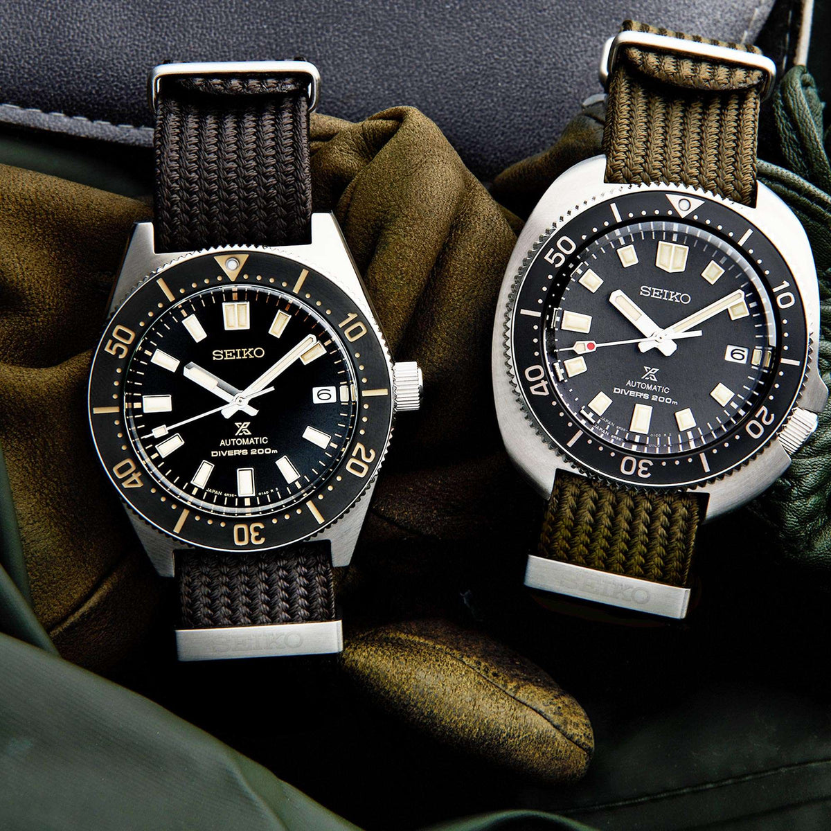 Two Seiko watches with black faces and brown straps on a textured surface.