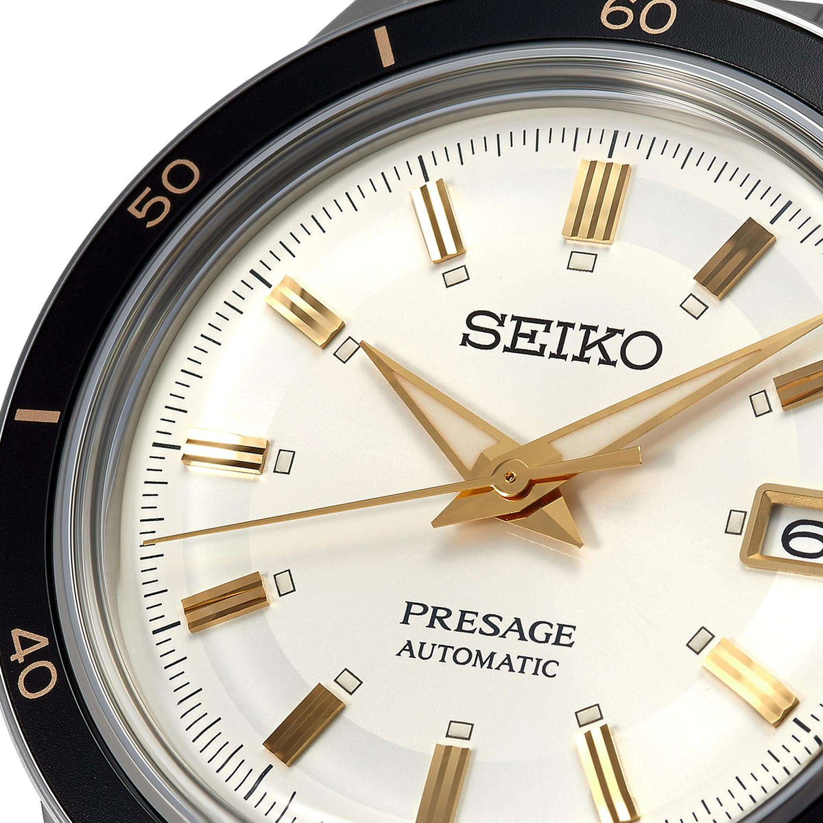 Close-up of white dial men's automatic watch with gold hour markers and Seiko branding
