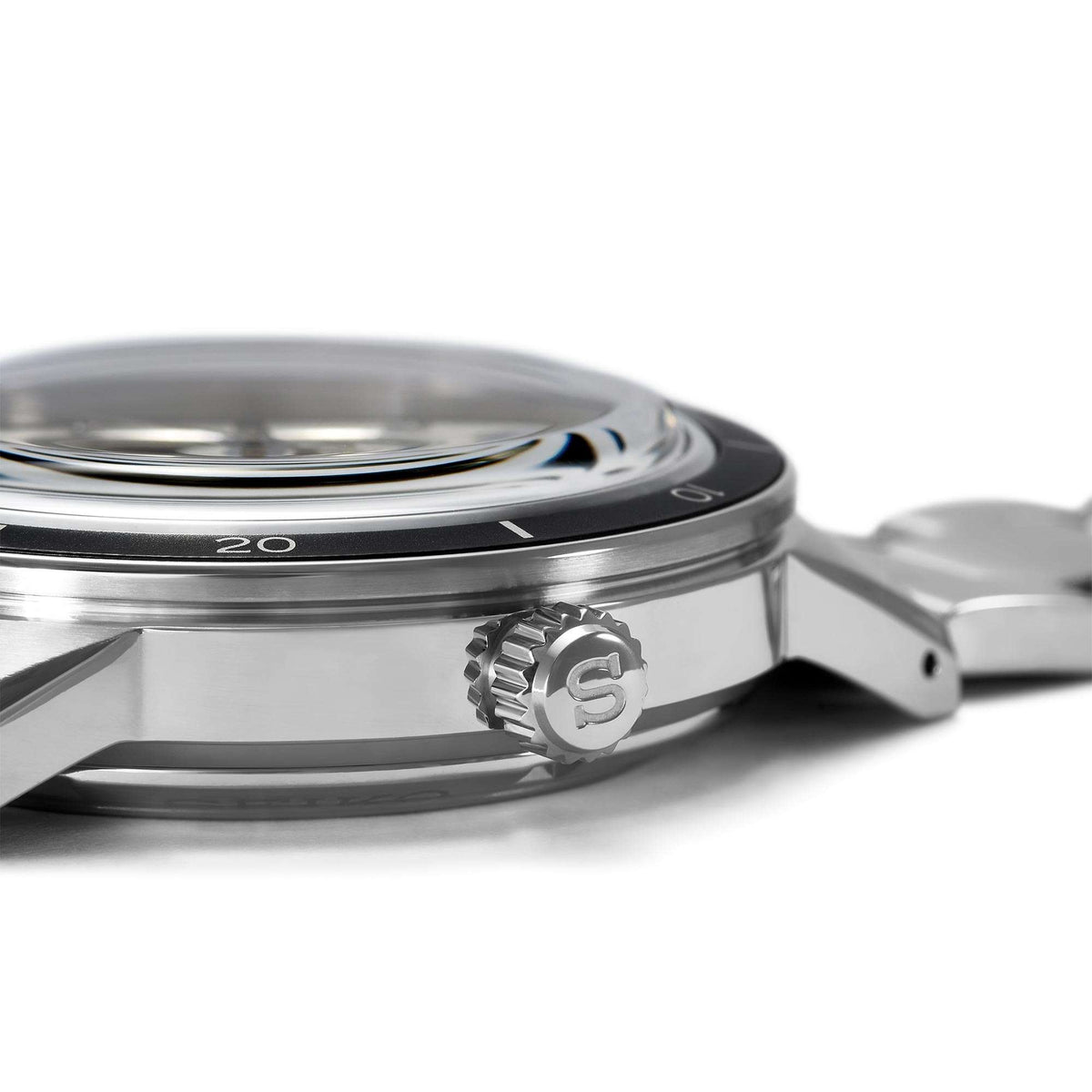 Stainless steel watch case side with crown and black bezel rim detail