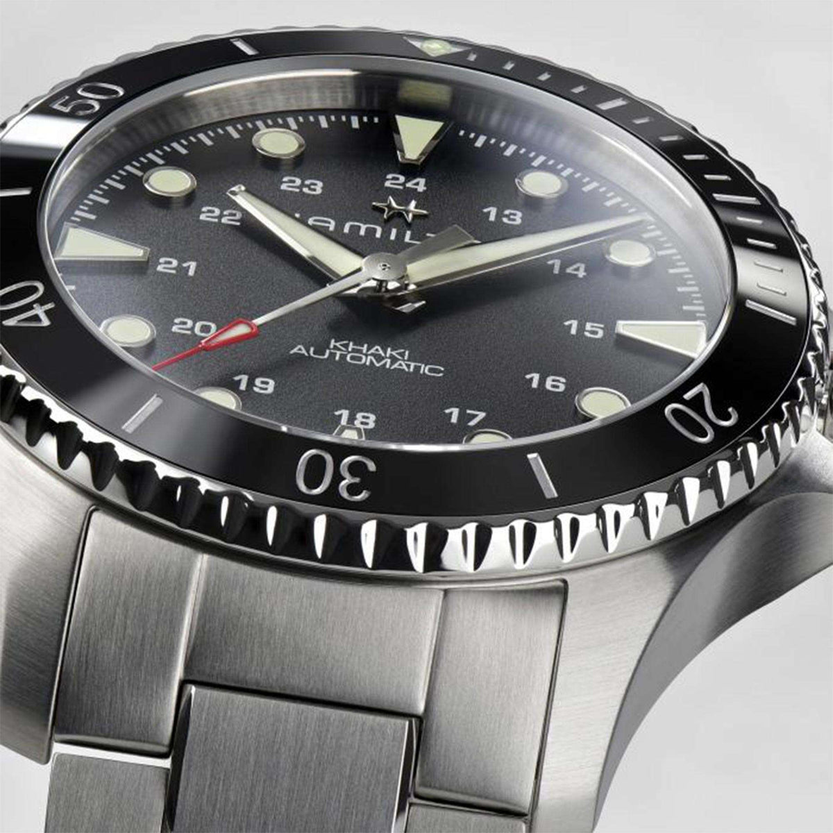 Hamilton Khaki Navy 43mm H82515130 black dial with red-tipped seconds hand and ceramic bezel close-up