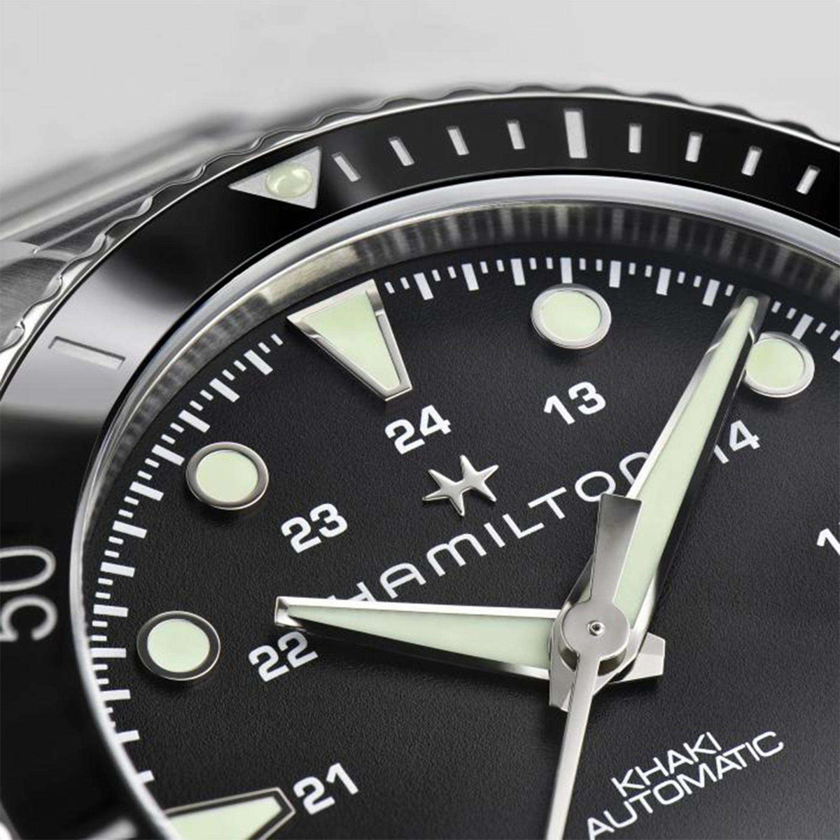 Hamilton H82515130 black dial with red-tipped seconds hand and ceramic bezel close-up