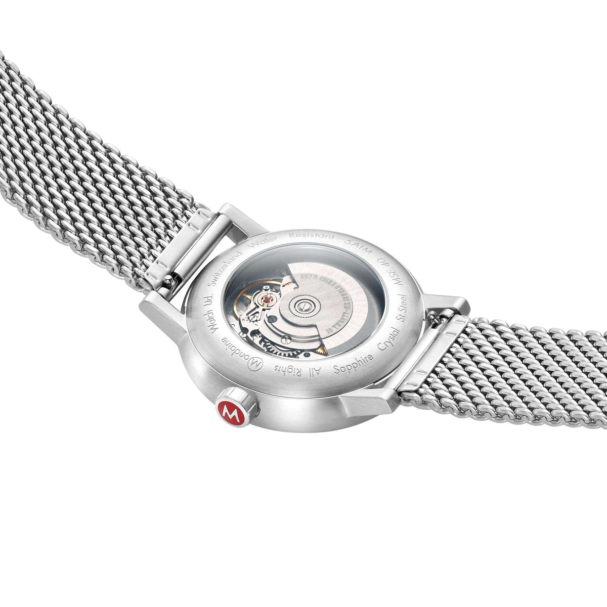 Stainless steel automatic watch showing caseback and mesh bracelet, angled view