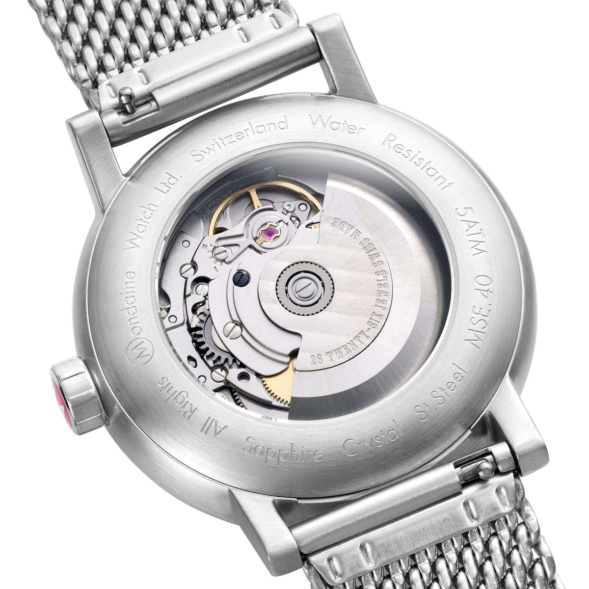Stainless steel watch caseback with visible automatic movement and mesh bracelet