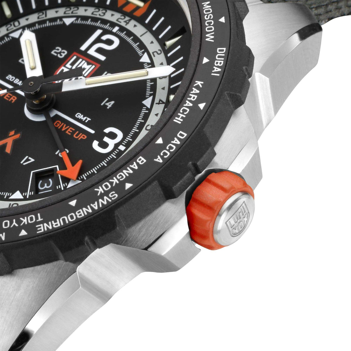 Survival watch close-up: black bezel, silver case, orange-capped crown