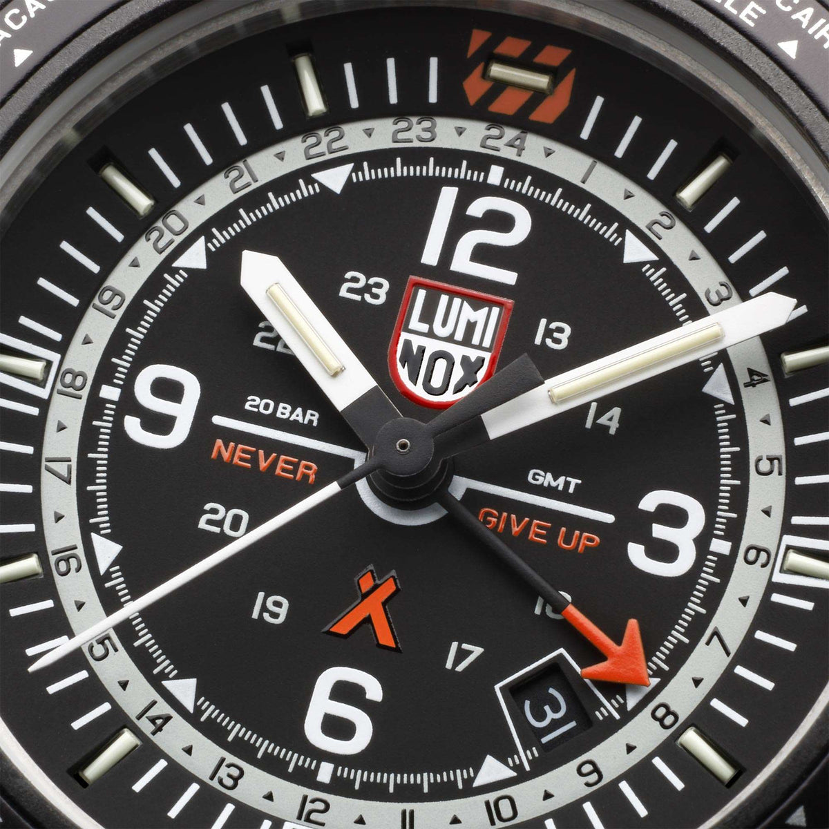 Close-up of black watch dial with large white numerals and orange GMT indicator hand