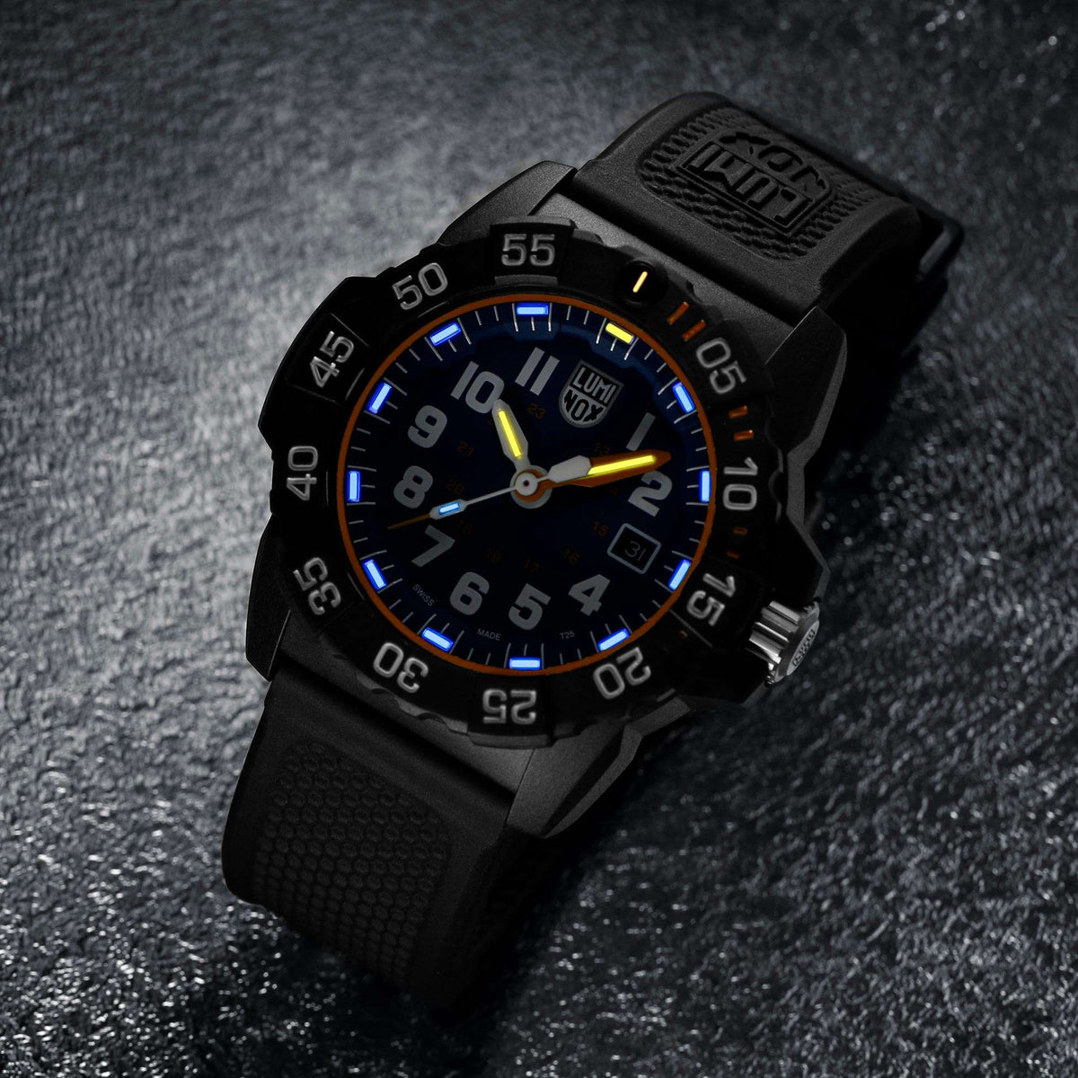 Angled view of men's blue dial dive watch with black rubber strap and black bezel markers