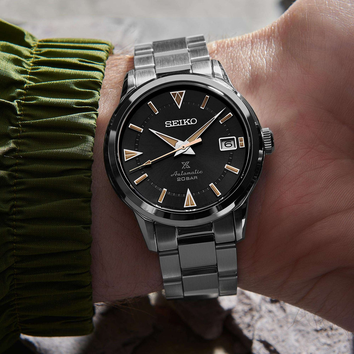 Automatic men's stainless steel watch, black dial with gold hands, date window, on bracelet