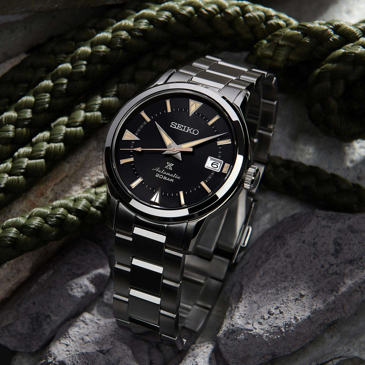 Automatic stainless steel watch with black dial, gold indices, date window, metal bracelet