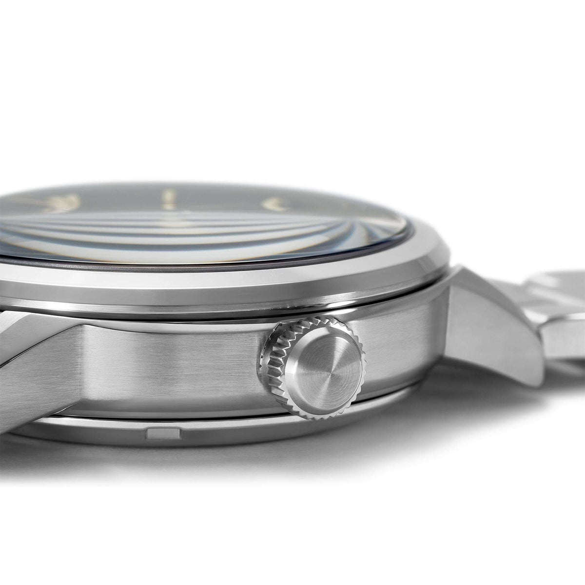 Stainless steel watch case side view with crown and ridged bezel