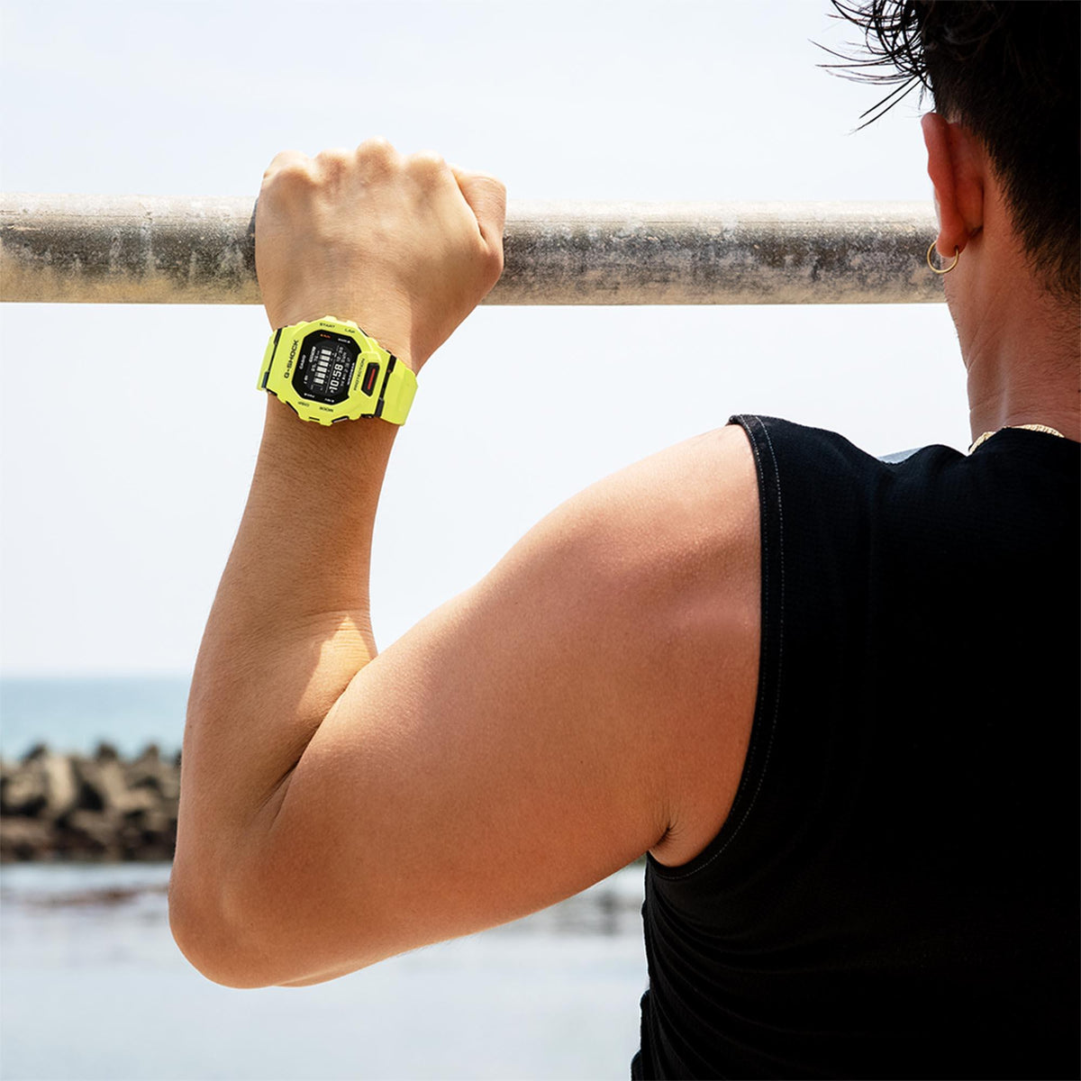 Neon green digital resin strap men's G-Shock watch on raised wrist