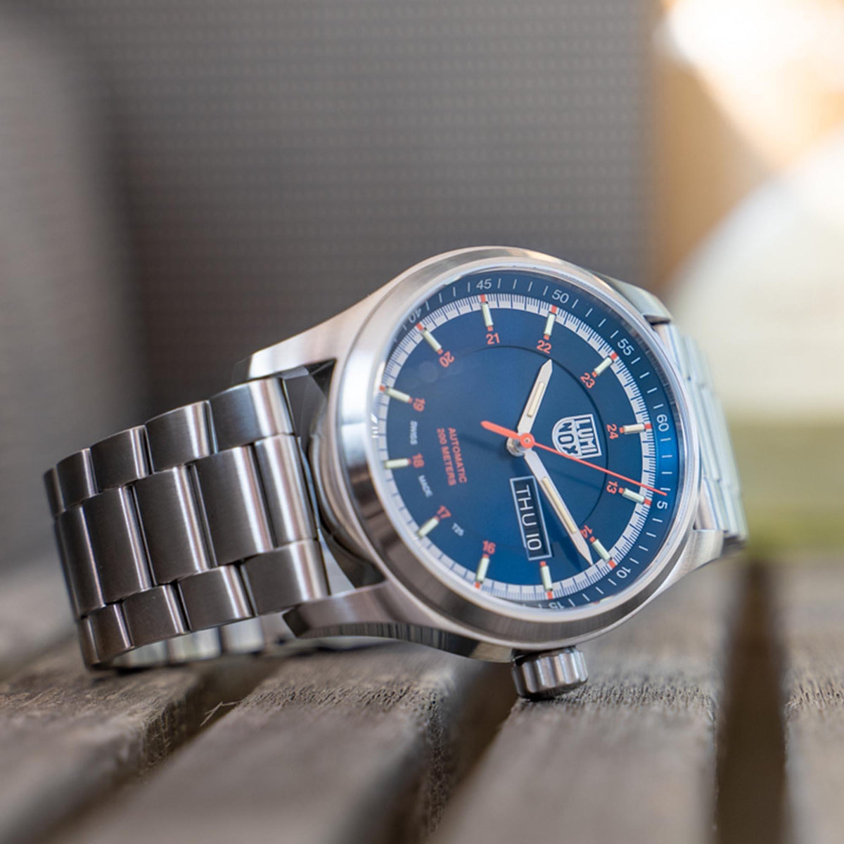 Men's automatic wristwatch on wrist, blue dial and steel bracelet