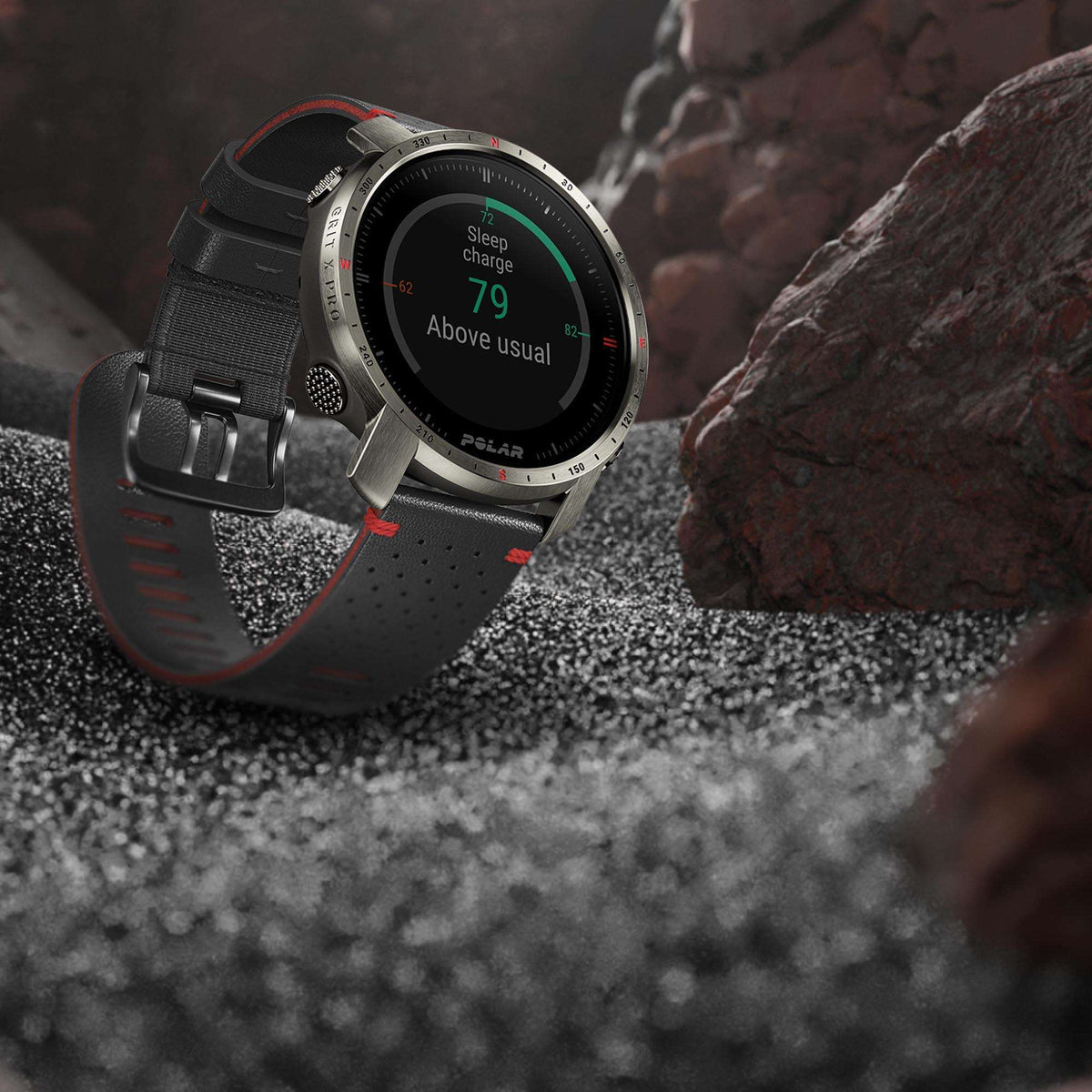 Titan grey sports watch on rugged rocks, black perforated rubber strap and active display