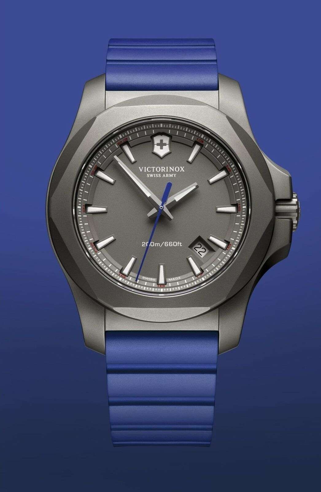 Men's Victorinox titanium quartz watch angled front view with blue rubber band and dark dial