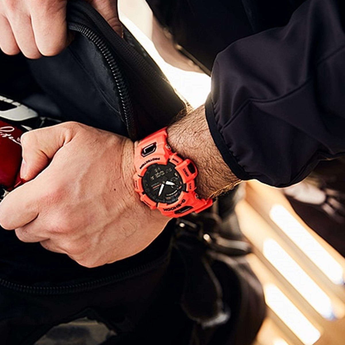 Casio G-Shock men’s quartz watch on wrist, red resin strap over black dial