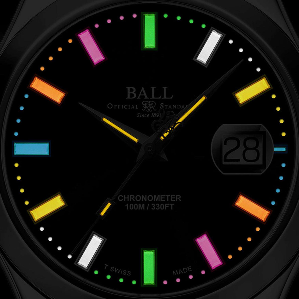 Black watch dial close-up with multicolor luminous bars and date window at 28