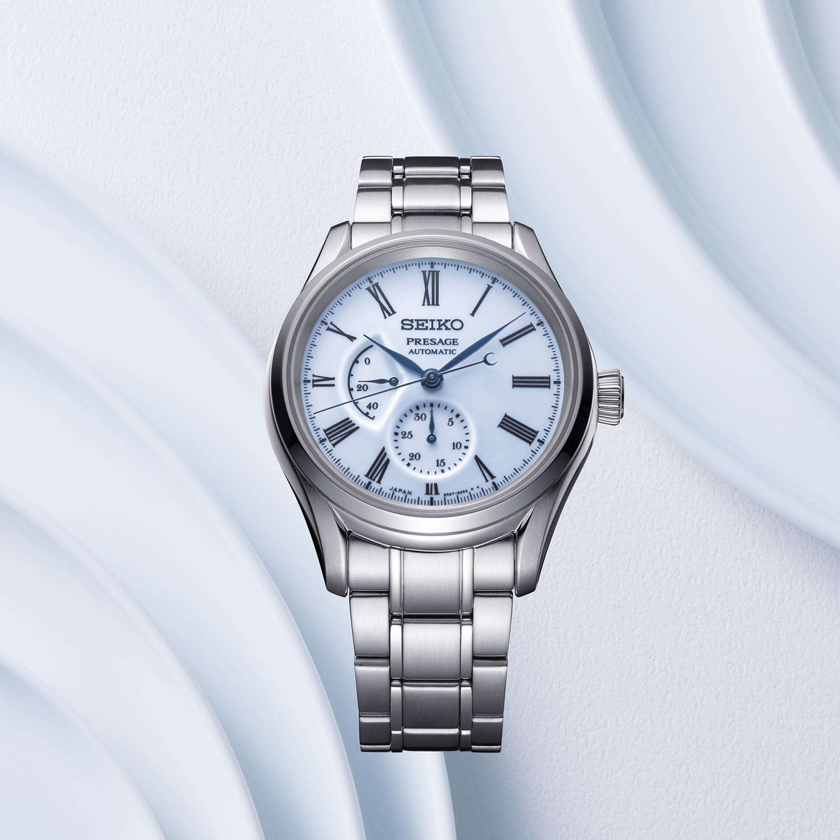Men's automatic steel watch with blue dial, Roman numerals, and subdial at 6
