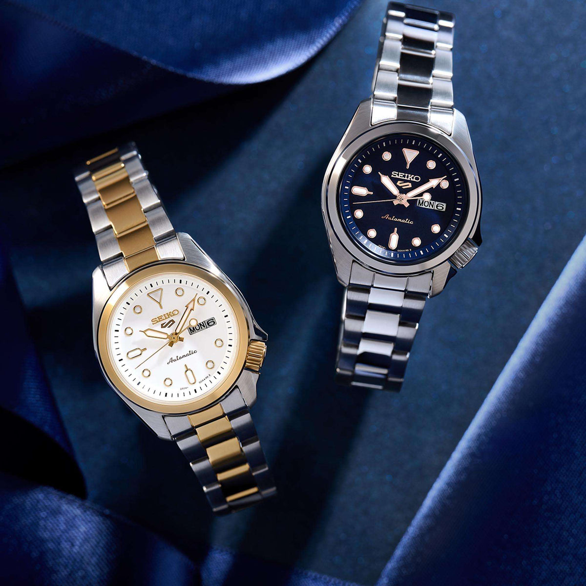 Two-tone stainless steel ladies watch with white dial and day-date display, gold markers