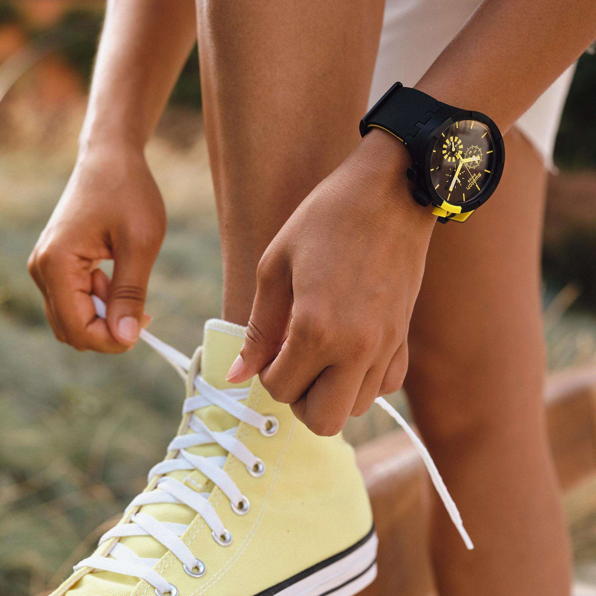 Black and yellow silicone strap watch on wrist