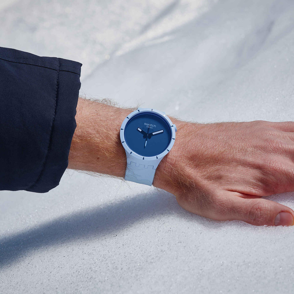 Blue dial bioceramic watch with light blue silicone band worn on wrist
