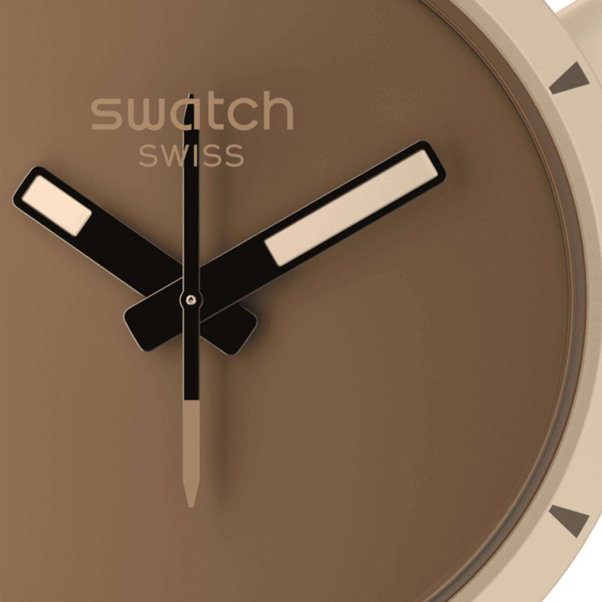 Close-up of Swatch watch dial: brown face, black cross hands, striped hour markers.